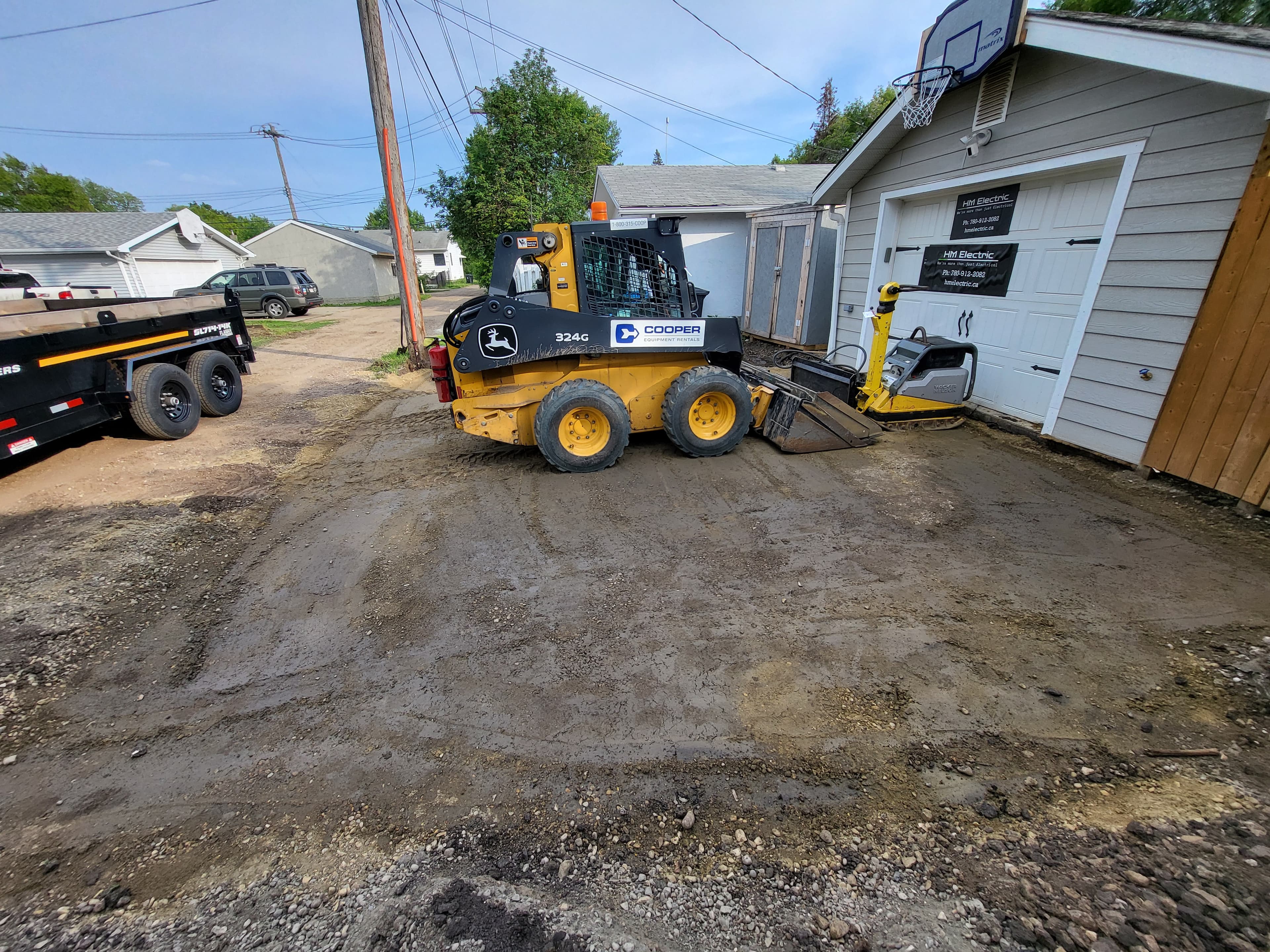 Skid steer grading a driveway